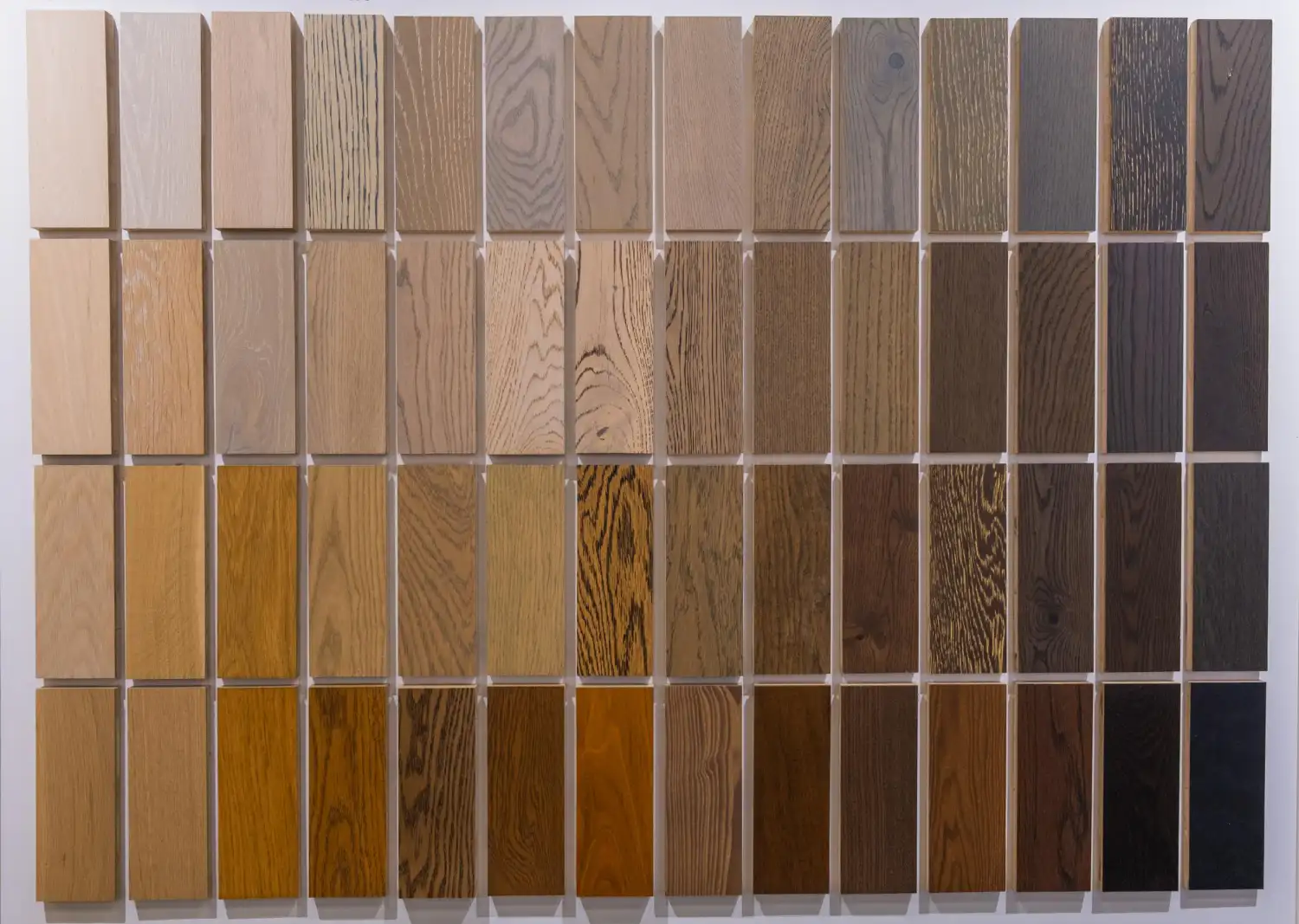 Panel of wood stain samples on oak, arranged light to dark, used to approve a restaurant table finish