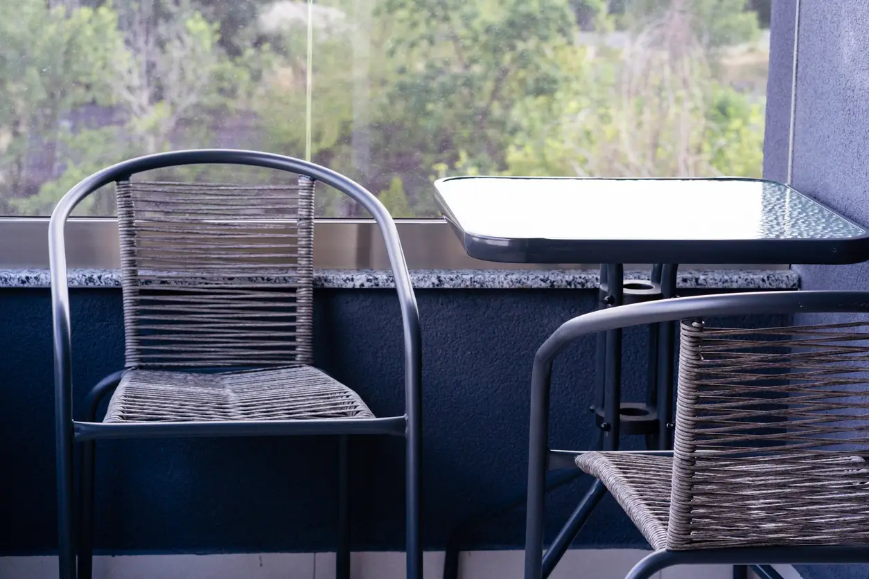 Metal-framed table top where the frame itself acts as the table top edge profile