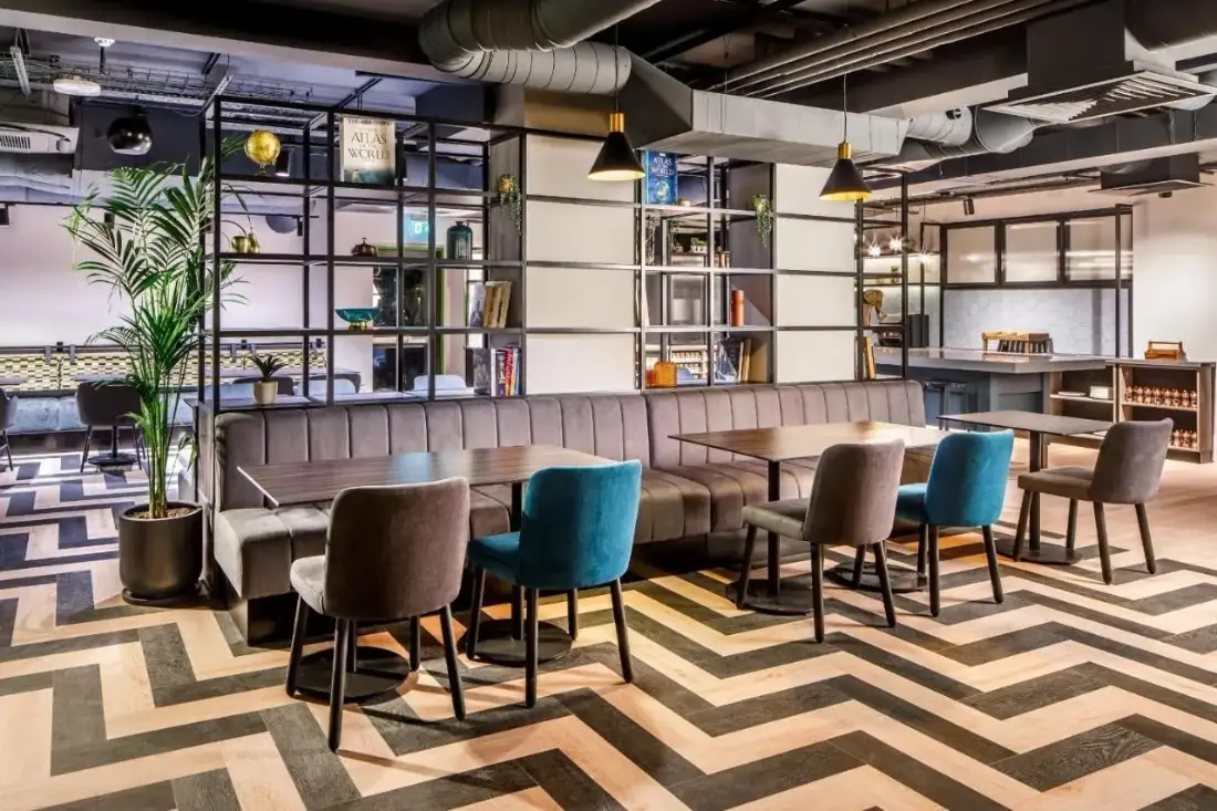 Cafe lounge seating from a restaurant furniture manufacturer in Turkey, with a grey velvet banquette and teal chairs