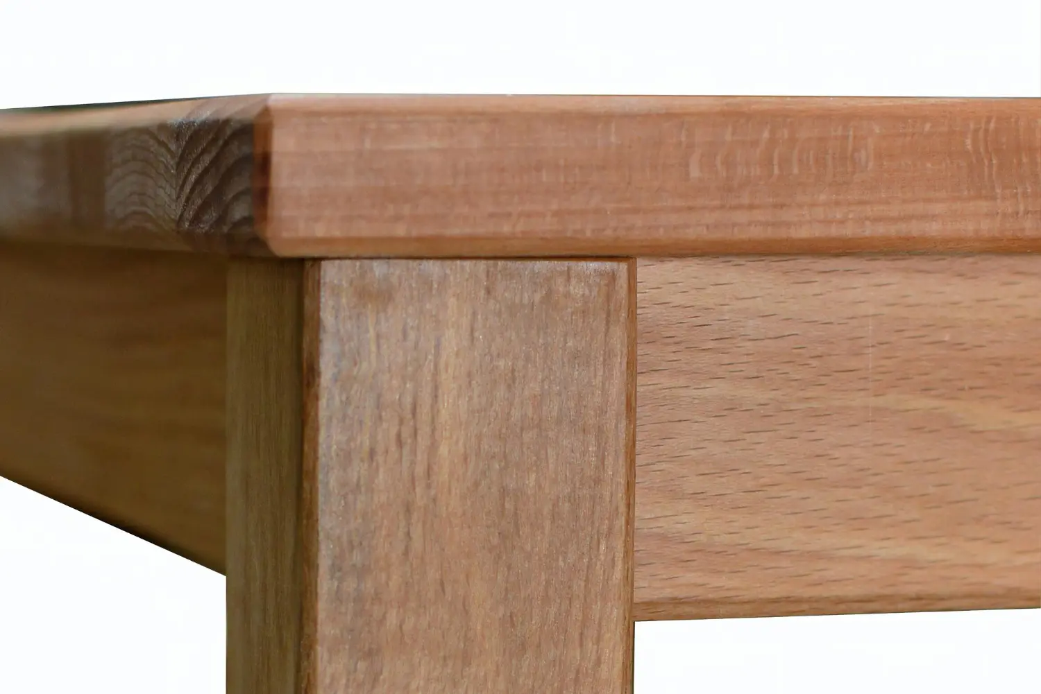 Square timber table corner with an eased edge, showing why the table top edge profile and corner radius are separate lines
